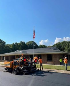Professional asphalt paving crew resurfacing commercial property