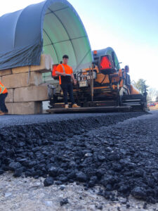 Commercial asphalt paving crew laying fresh pavement