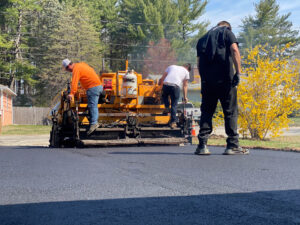 Commercial asphalt paving crew laying fresh pavement