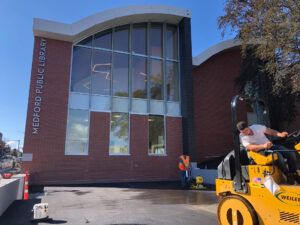 Commercial asphalt paving project at public library entrance