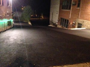 Nighttime commercial parking lot asphalt resurfacing service