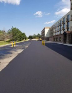 Freshly paved commercial roadway beside office building