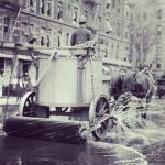 Early 1900s asphalt paving workers and construction equipment